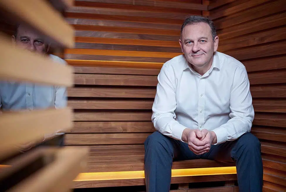  team member sitting in a sauna